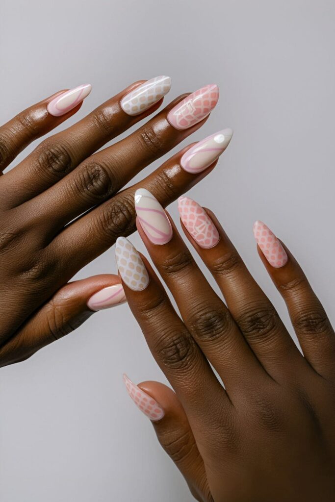 Acrylic nails featuring a combination of pink and white patterns, such as stripes and polka dots, designed for dark skin tones