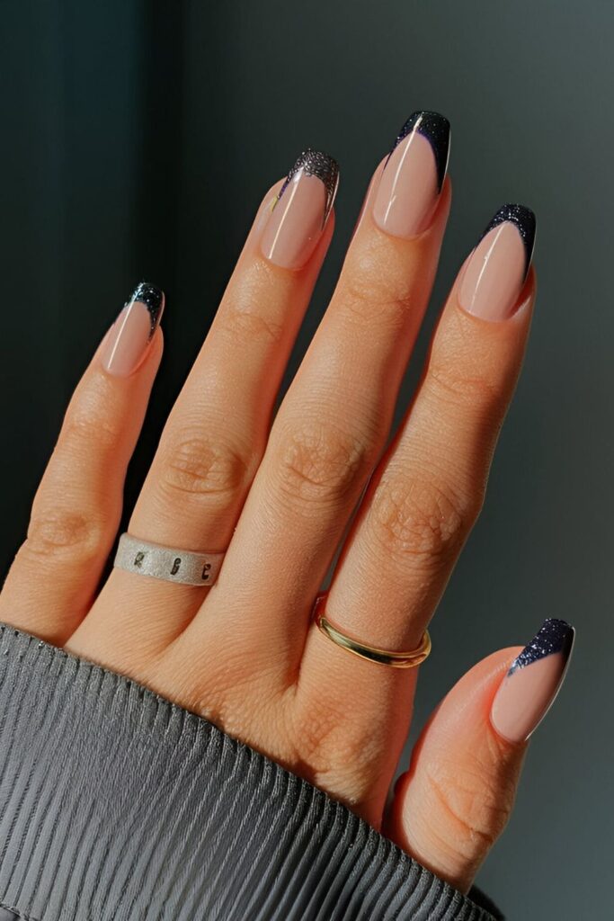 Acrylic nails with a bright colored base and glitter or black tips, showcasing a timeless French tip design