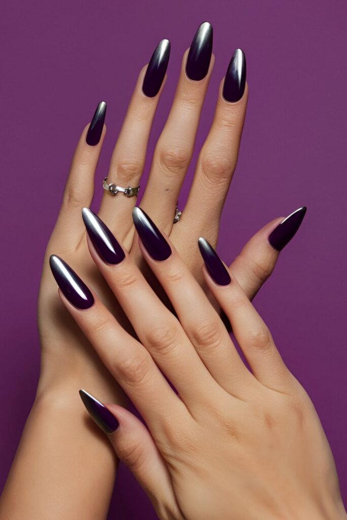 Acrylic nails with a deep purple base that seamlessly blends into shiny silver tips, creating a chic and modern gradient effect