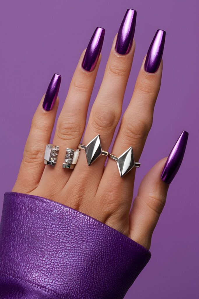 Acrylic nails with a metallic purple finish, paired with sleek, geometric silver designs for a futuristic and edgy look