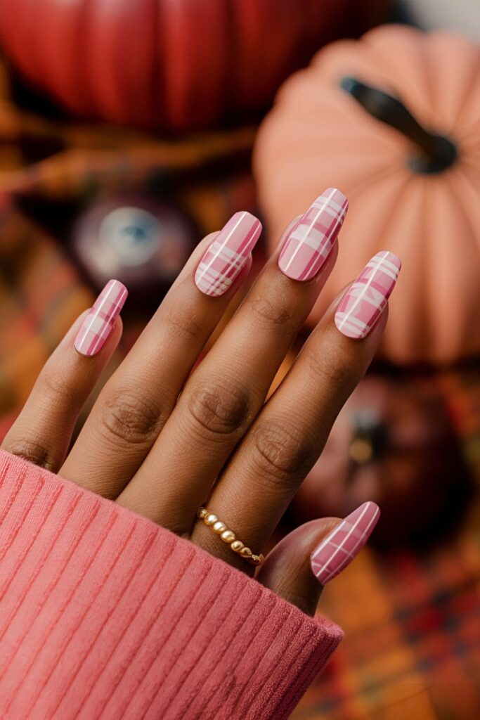 Acrylic nails with a pink plaid pattern, incorporating various shades of pink, designed to enhance dark skin tones