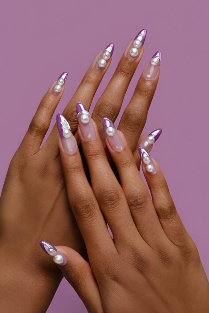 Acrylic nails with a purple base, adorned with pearl accents and touches of silver for a sophisticated and elegant design