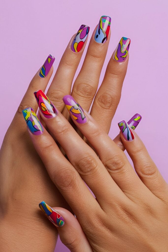 Acrylic nails with a purple base, decorated with bold and colorful pop art designs for a fun and standout look