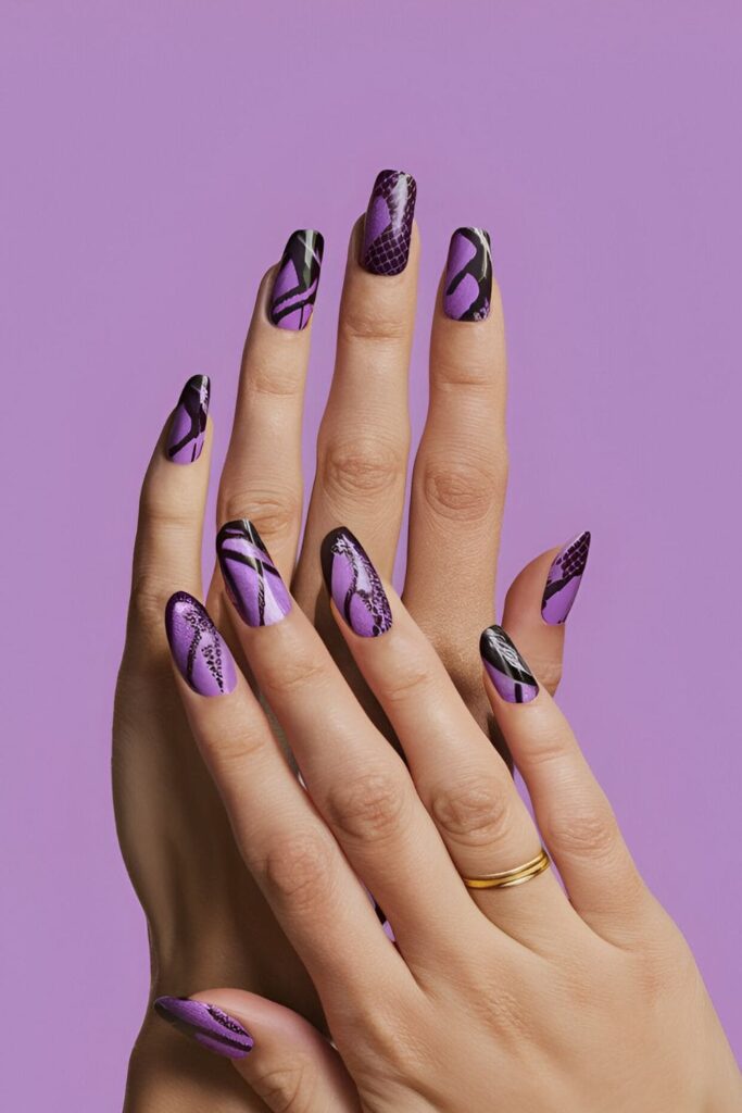 Acrylic nails with a purple base, featuring an exotic snake skin pattern in black and lighter purple shades for a bold design