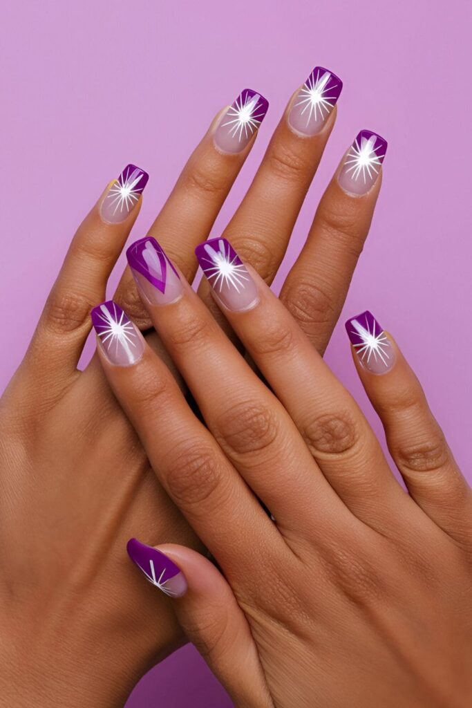 Acrylic nails with a purple base, featuring bright starburst patterns in white or silver for a vibrant and eye-catching design