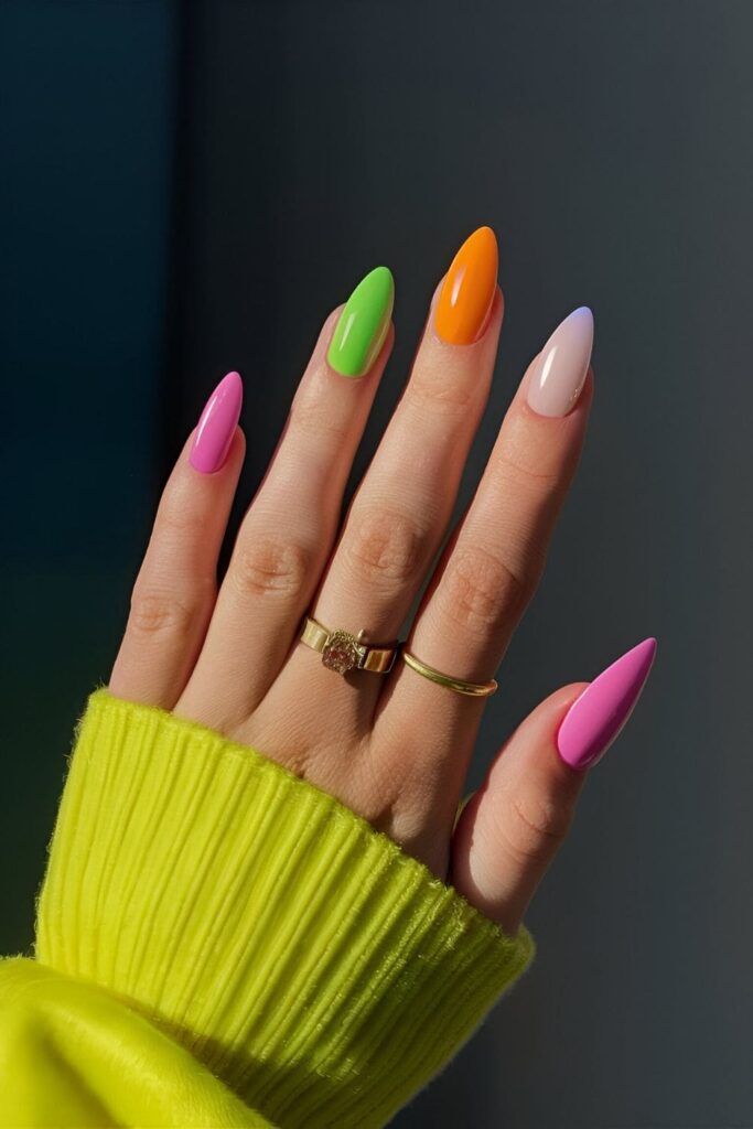 Almond nails with neon colors like electric pink, green, orange, and yellow