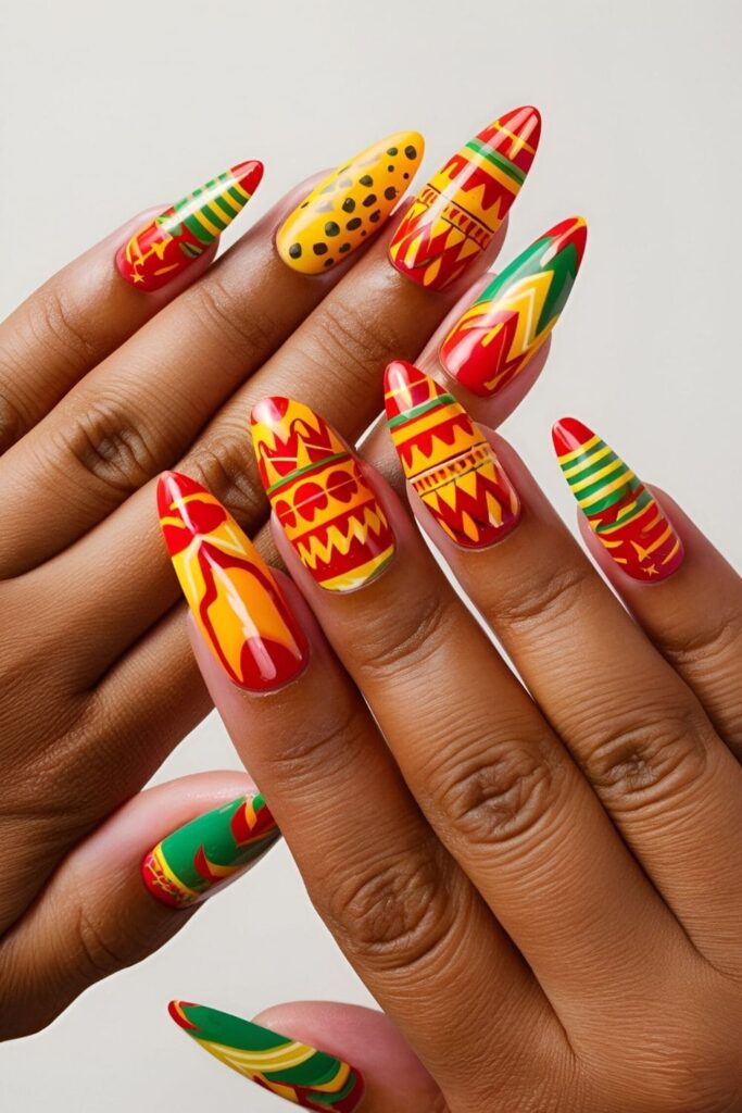 Almond nails with vibrant fiesta-inspired patterns in bright red, yellow, and green, including zigzags, dots, and stripes