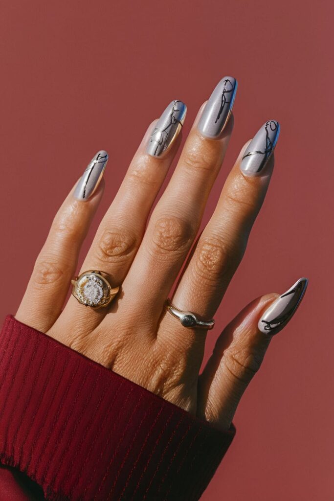 Artistic nails with abstract silver shapes, lines, and patterns on a clear or colored base