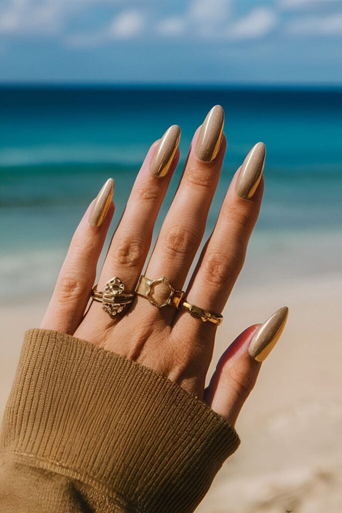 Aura nails in shades of gold, beige, and brown, capturing the warm, luxurious feel of golden sands