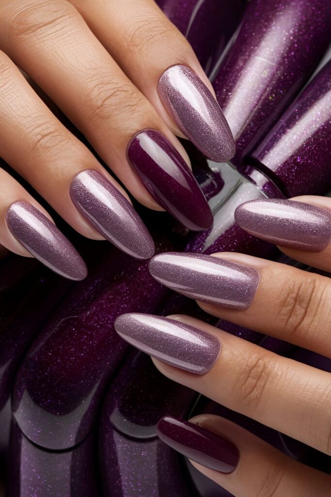 Aura nails with deep purple shades ranging from lavender to plum, enhanced with glitter for a luxurious effect