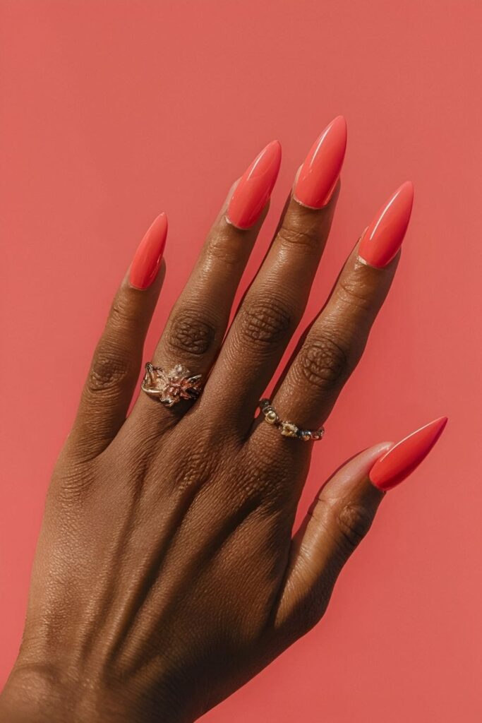 Aura nails with vibrant coral shades for a fresh, lively summer look