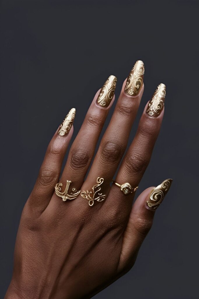 Baroque style nails with gold swirls and patterns on a dark base