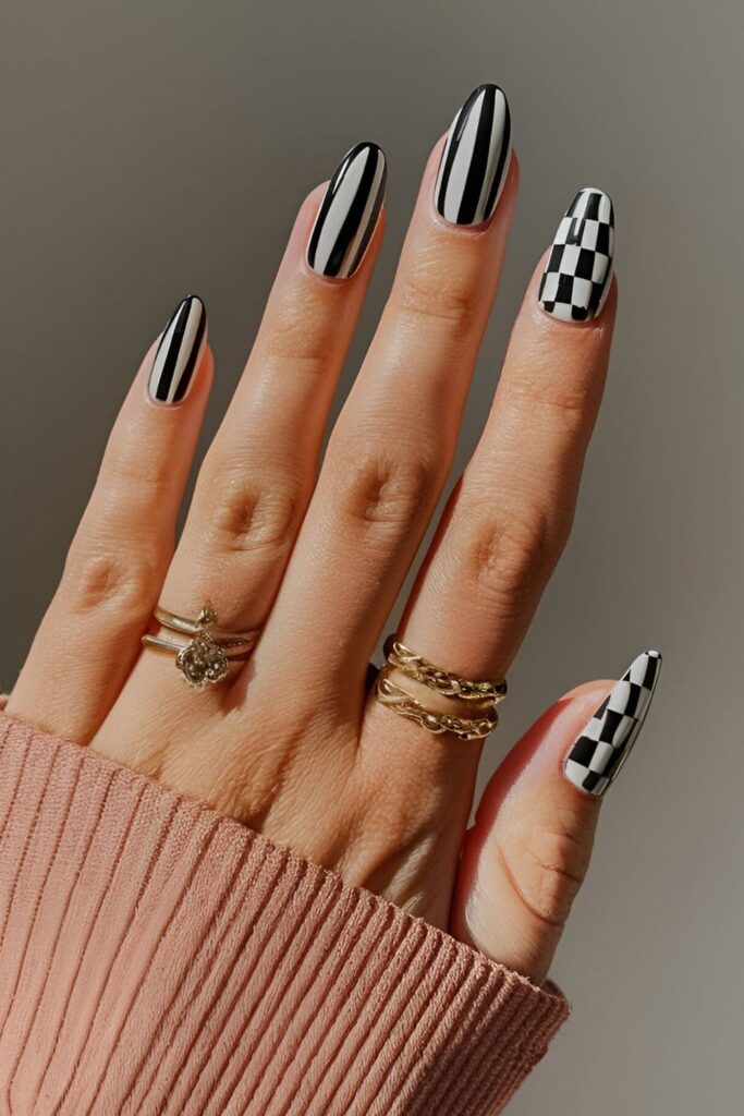 Black acrylic nails with chic black and white stripes and checkerboard patterns, timeless and stylish