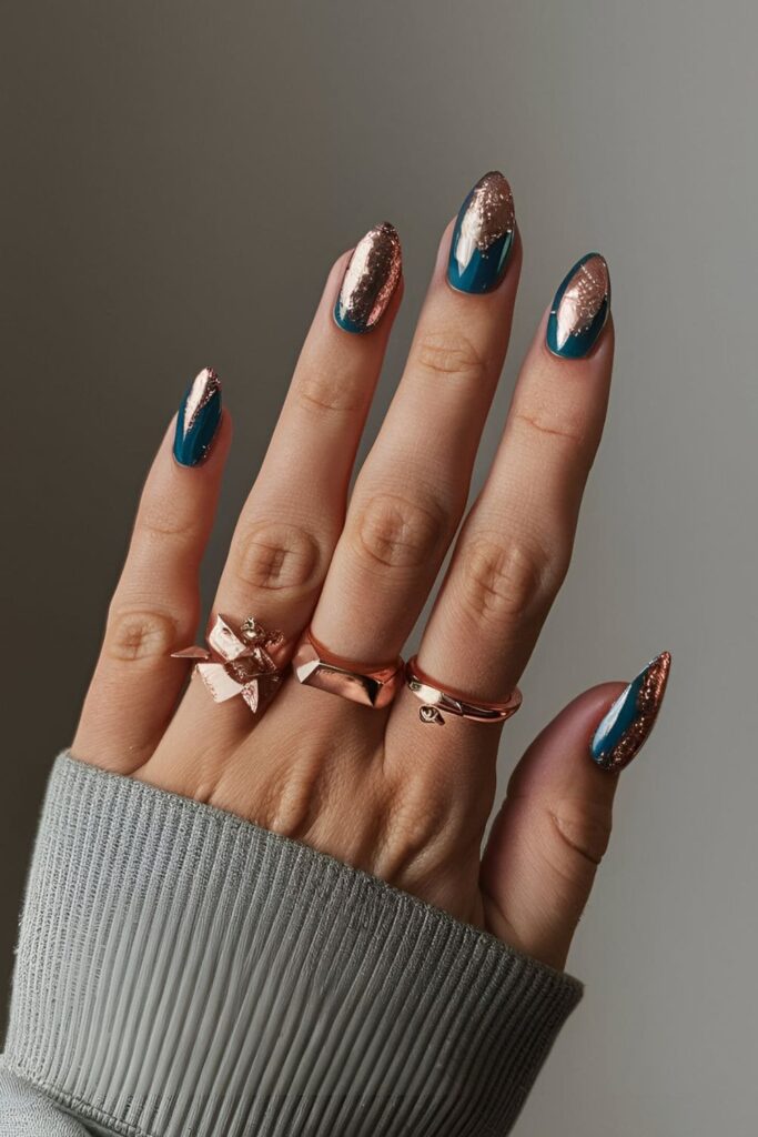 Blue acrylic nails adorned with rose gold foil or glitter