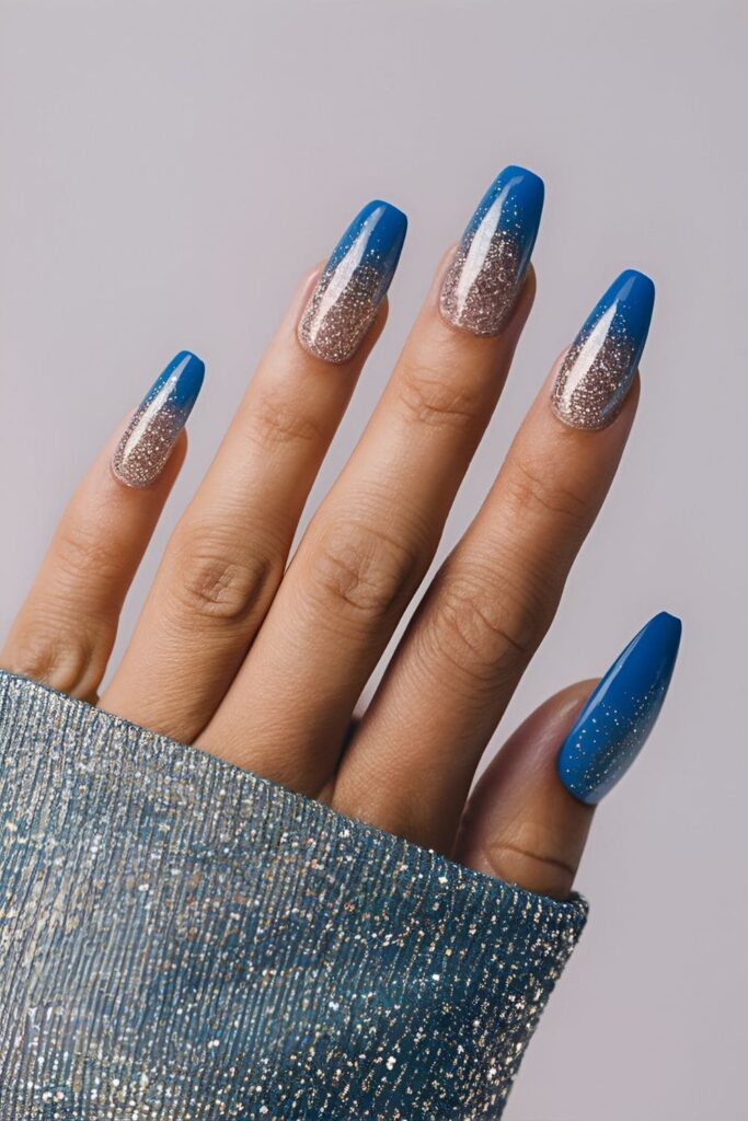 Blue acrylic nails with a gradient glitter effect