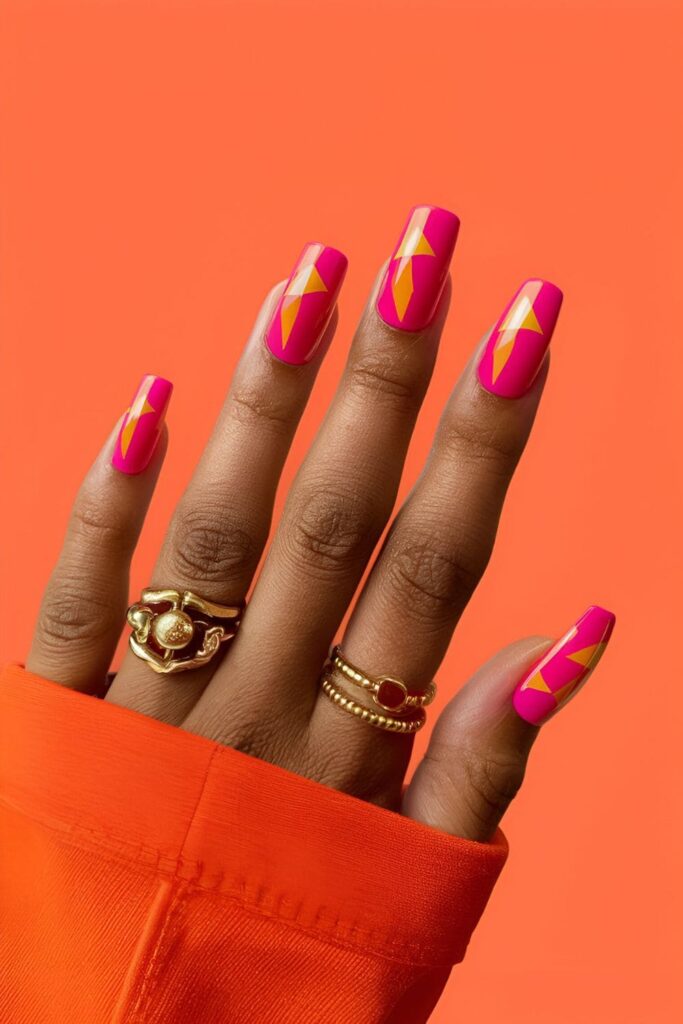 Bold neon pink accents or patterns on orange acrylic nails, lively and vibrant nail design