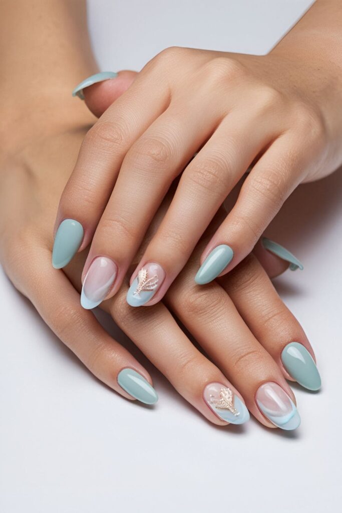 Calming acrylic nails with ocean-inspired shades of blue and white, featuring seashell and starfish accents, set against a plain background