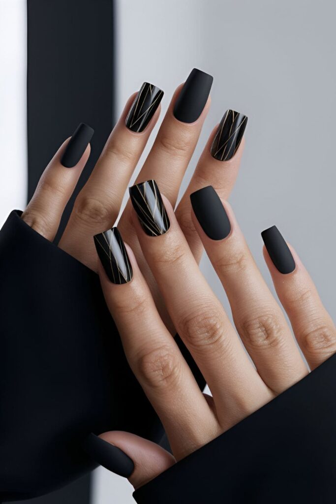 Chic matte black nails that make a bold statement, accented with glossy black or metallic designs for added elegance