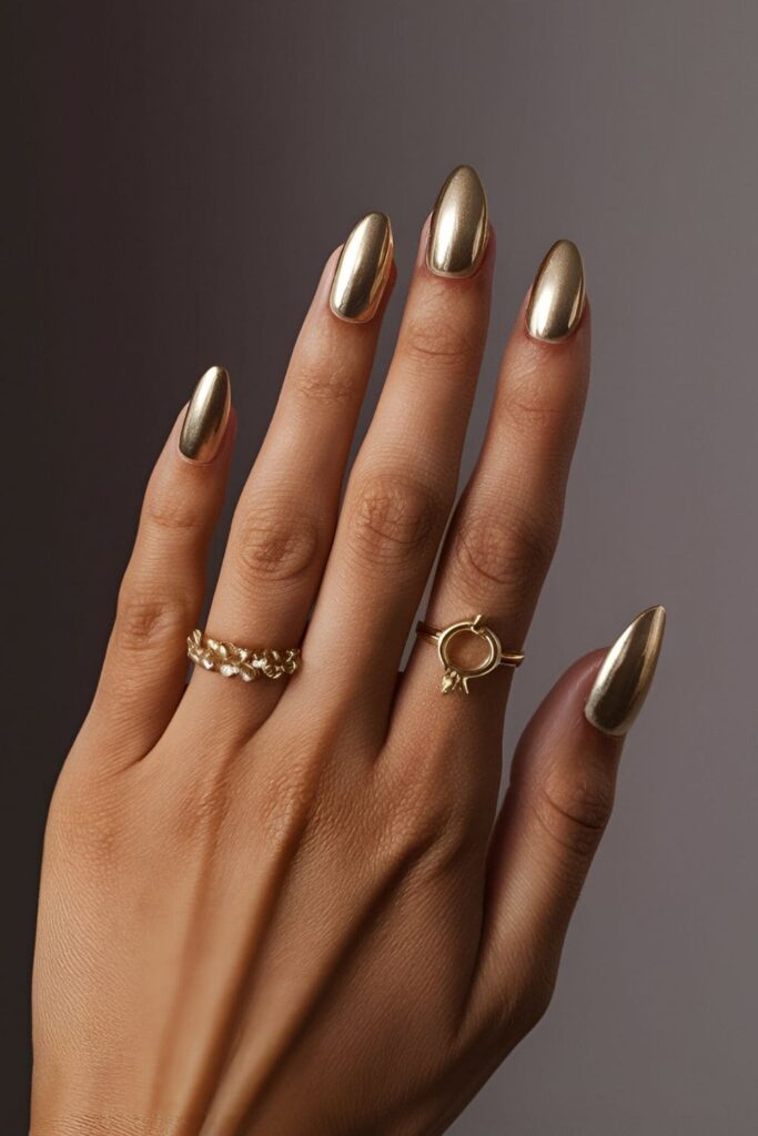 Close-up of classic gold acrylic nails with a glossy finish, exuding elegance and sophistication