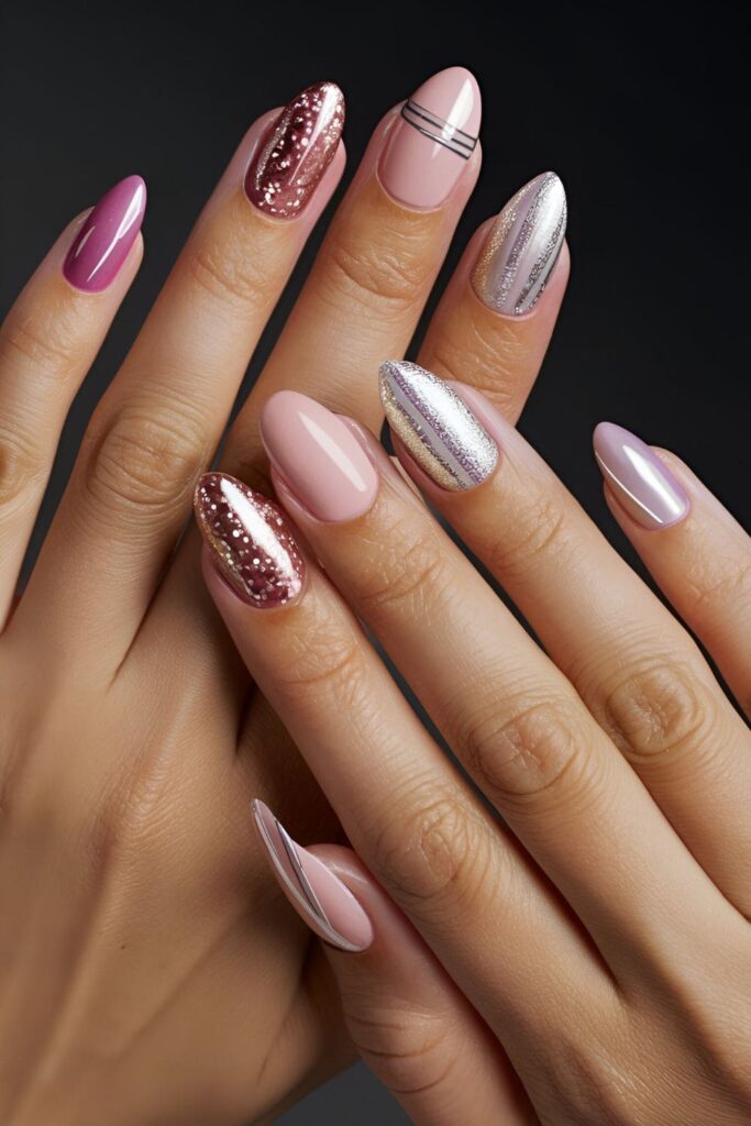 Close-up of fashionable pink acrylic nails with silver stripes and metallic accents