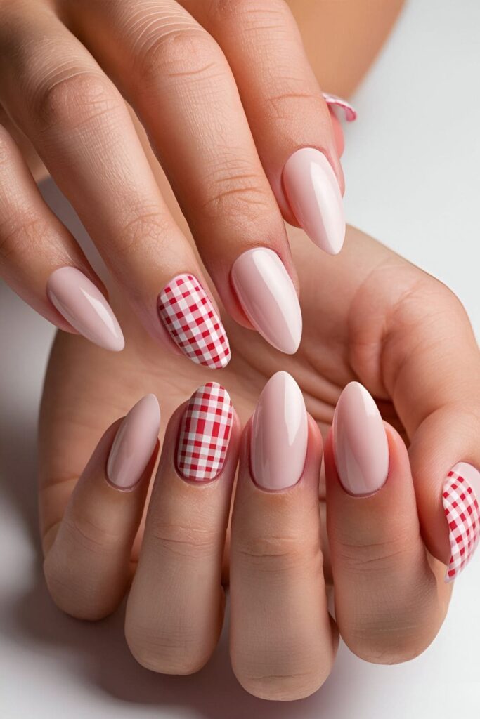 Close-up of pink acrylic nails with cute gingham pattern designs