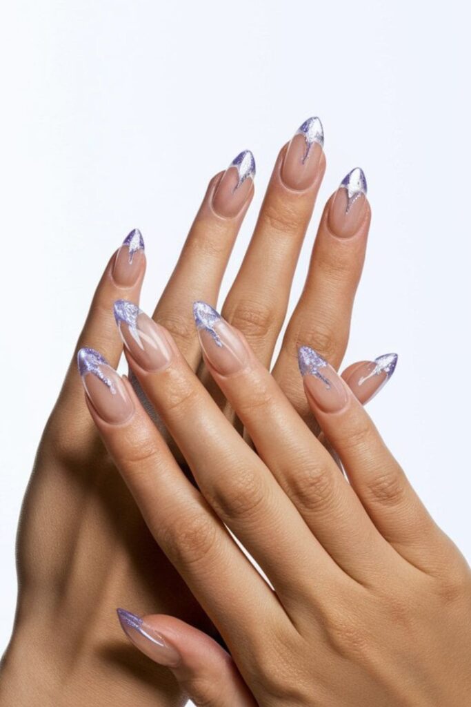 Crystal clear acrylic nails with purple accents, including purple designs or glitter, for a minimalist and chic summer look