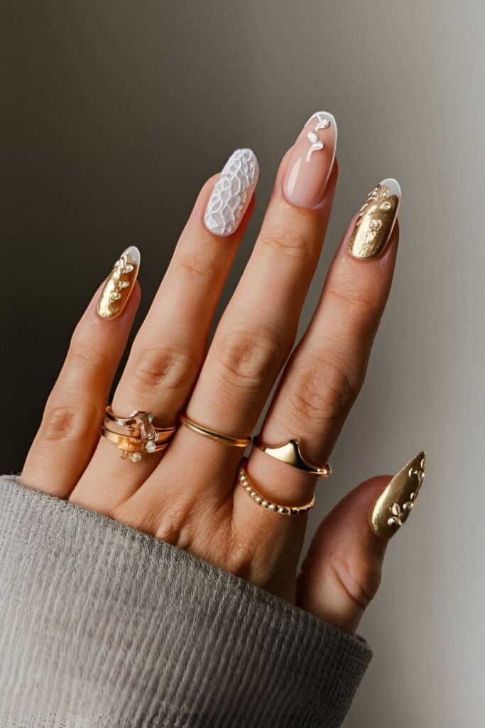 Delicate gold acrylic nails with intricate white lace patterns, perfect for weddings or romantic events