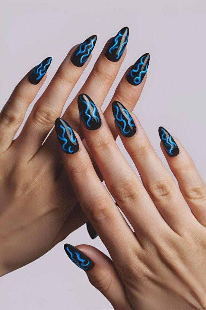 Edgy-nails-with-blue-flame-designs-on-a-dark-base-creating-a-dynamic-and-bold-look