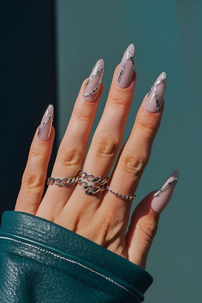 Edgy nails with intricate silver chain designs, adding bold and fashionable accents