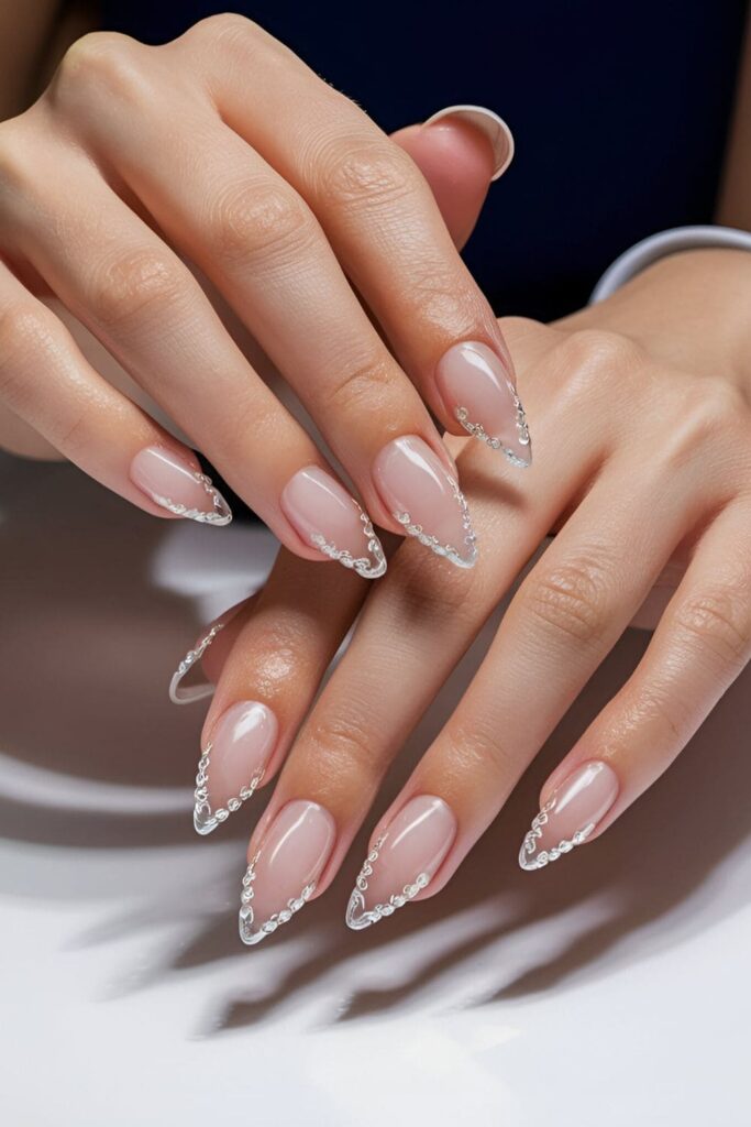 Elegant nails with classic French tips accented by small crystals along the smile line, ideal for weddings