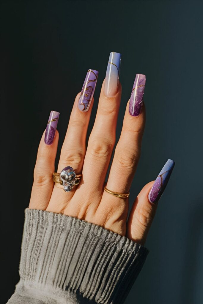 Geode-inspired nail art with purple and blue tones