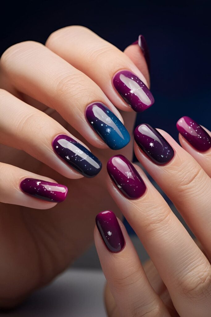 Gradient nails in deep purples and blues, scattered with silver stars, capturing the beauty of twilight and celestial magic






