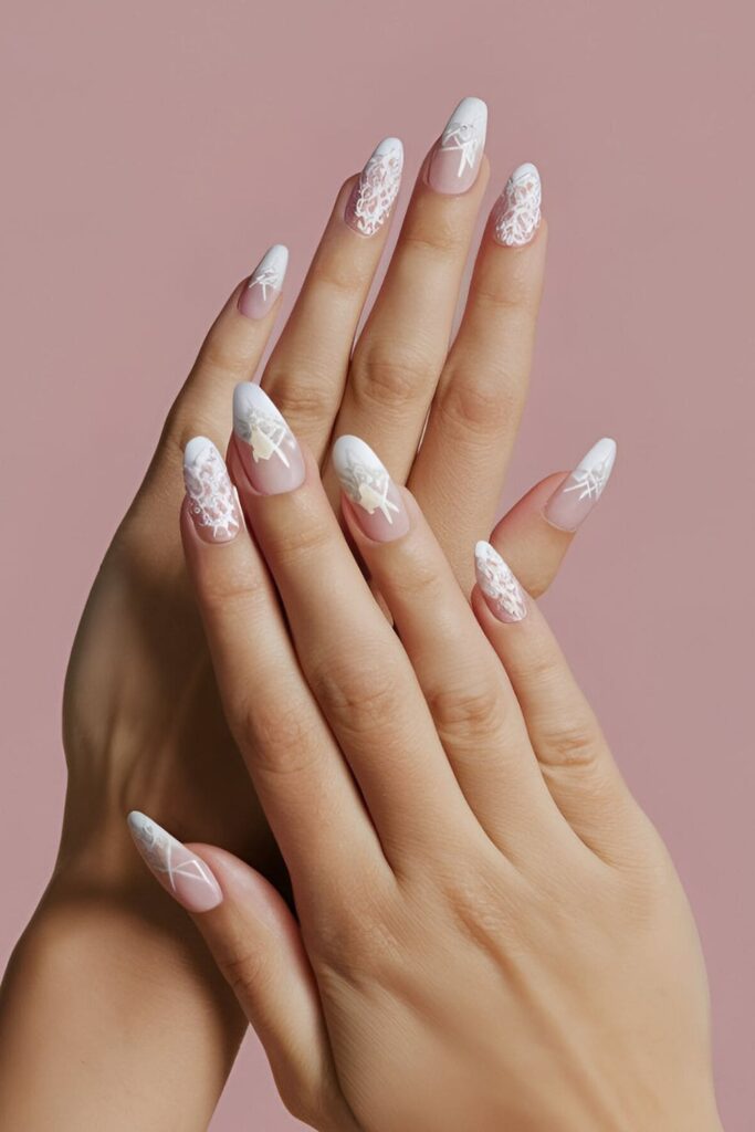 Image of hands with acrylic nails featuring a light, neutral base and delicate lace patterns in white or pale colors, emphasizing a feminine and elegant design