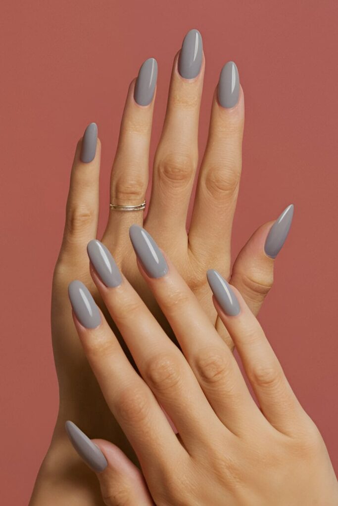 Image of hands with acrylic nails in a light grey shade, showcasing a sophisticated and modern color choice perfect for a refined look