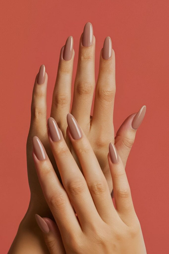 Image of hands with acrylic nails in a light, soft brown shade, offering a chic and sophisticated look ideal for everyday wear