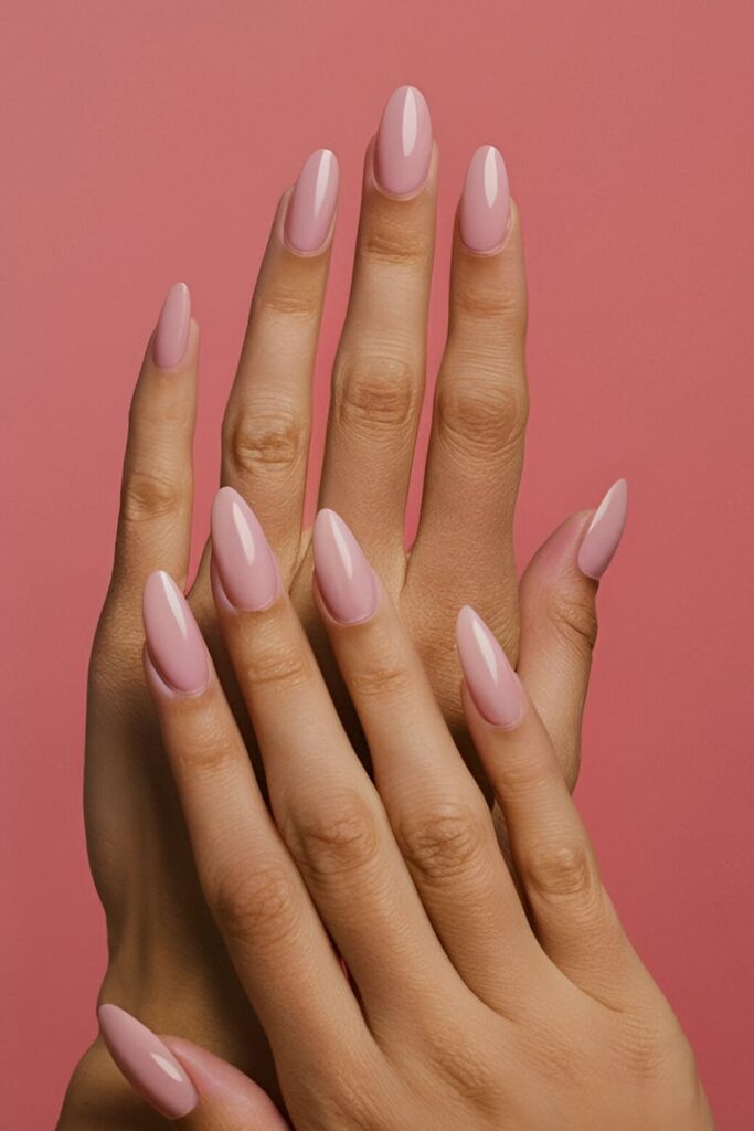 Image of hands with acrylic nails in a soft blush pink shade, adding a touch of color and elegance perfect for everyday wear