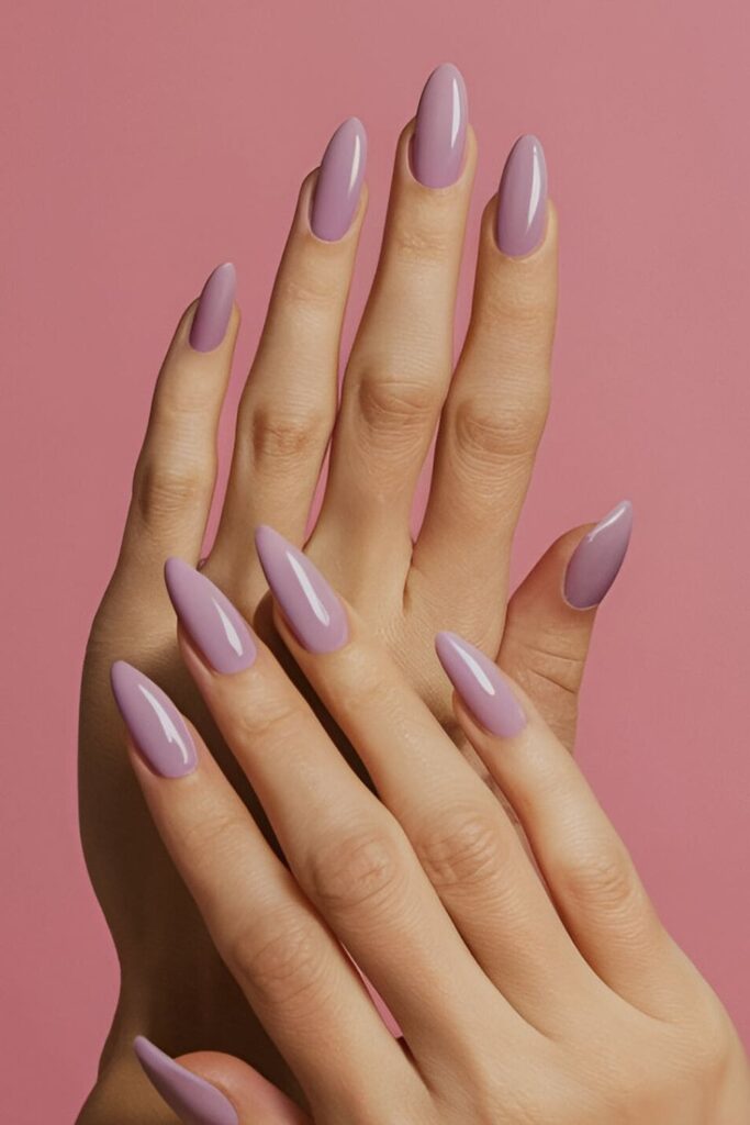 Image of hands with acrylic nails in a soft mauve shade, a blend of pink and purple, offering a subtle and elegant appearance