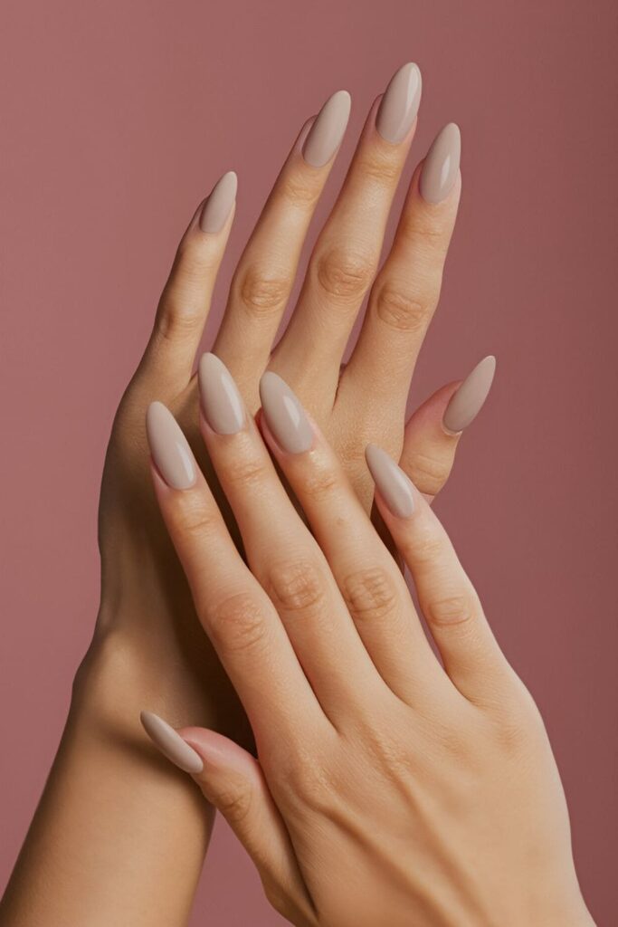 Image of hands with acrylic nails in neutral colors like beige or gray, with a modern matte finish for a chic and understated appearance