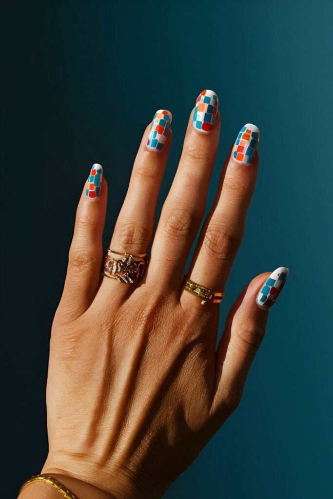 Intricate mosaic tile nails with tiny pieces of colored polish or decals