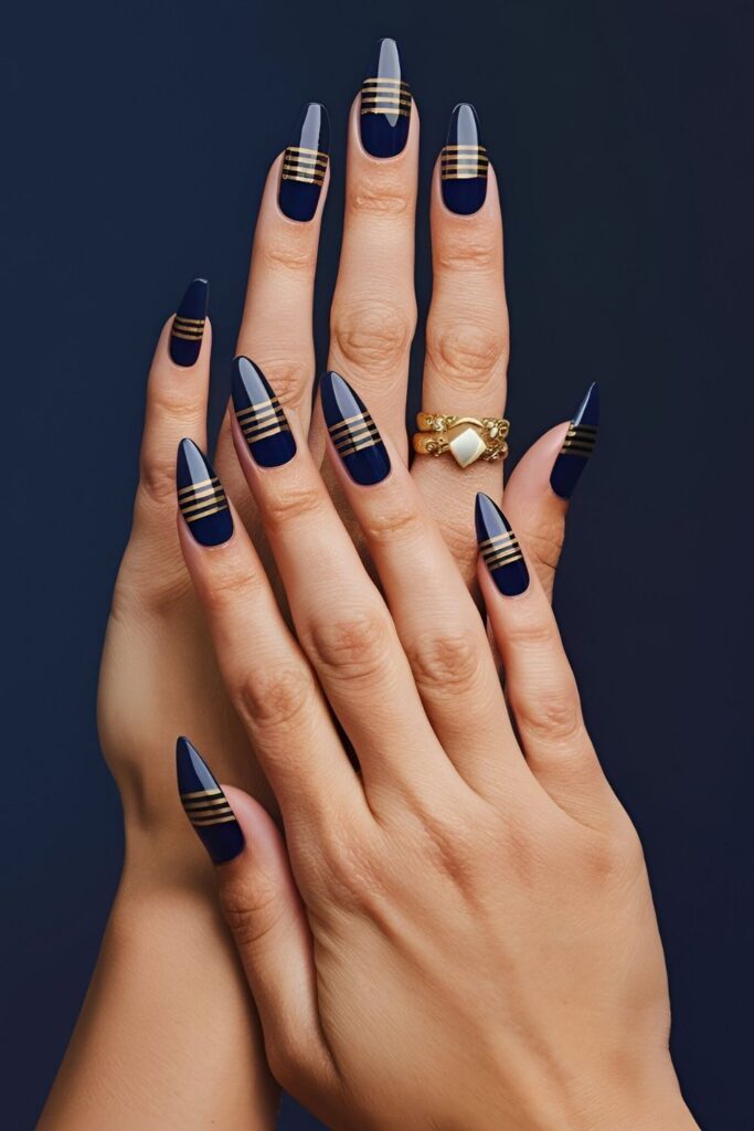 Luxurious-nails-with-blue-and-gold-accents-featuring-stripes-dots-and-an-accent-nail