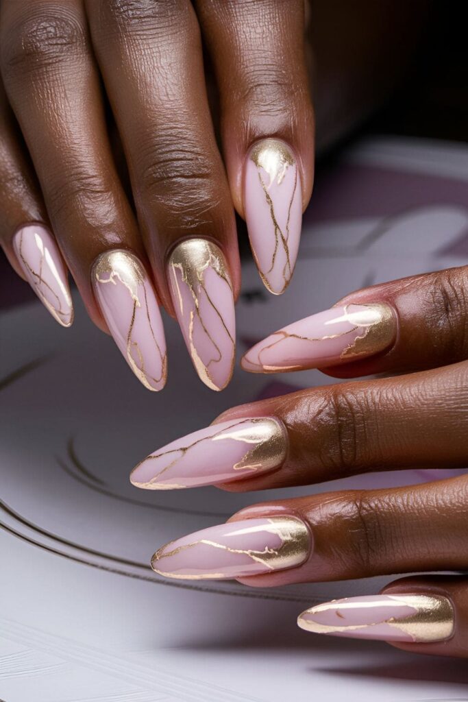 Luxurious pink and gold marble acrylic nails, featuring a swirling marble effect that complements dark skin tones