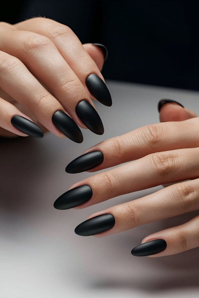 Matte black acrylic nails with glossy accents showcasing a modern and chic nail design