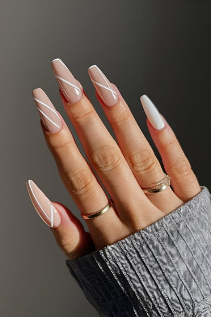 Minimalist nail art with black and white lines on nude base