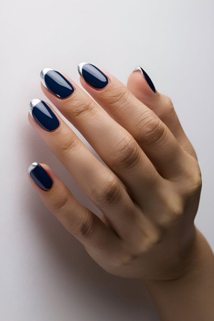 Modern French manicure with a royal blue base and silver tips, updating the timeless French tip design with a chic color combination