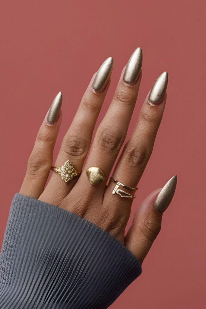 Modern and stylish gold acrylic nails with a matte finish, offering a sophisticated yet understated look