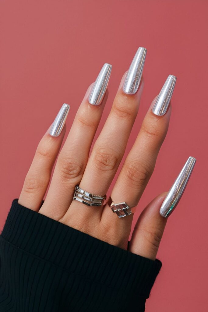 Modern nails featuring silver holographic tape in straight lines or geometric patterns for a futuristic effect