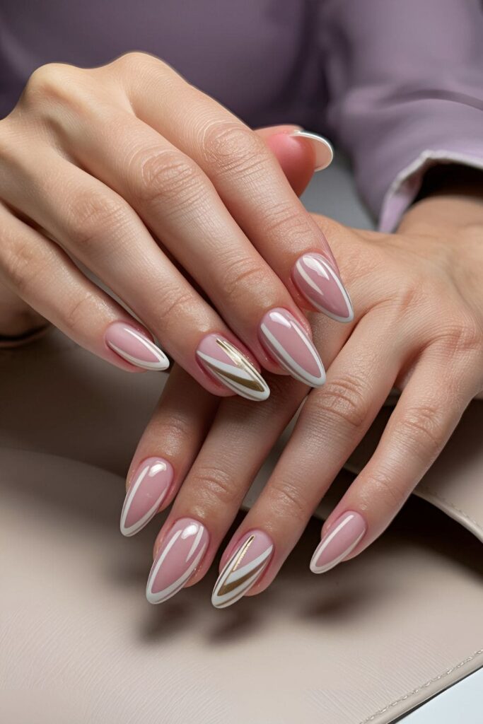 Modern pink acrylic nails with elegant white and gold stripe patterns