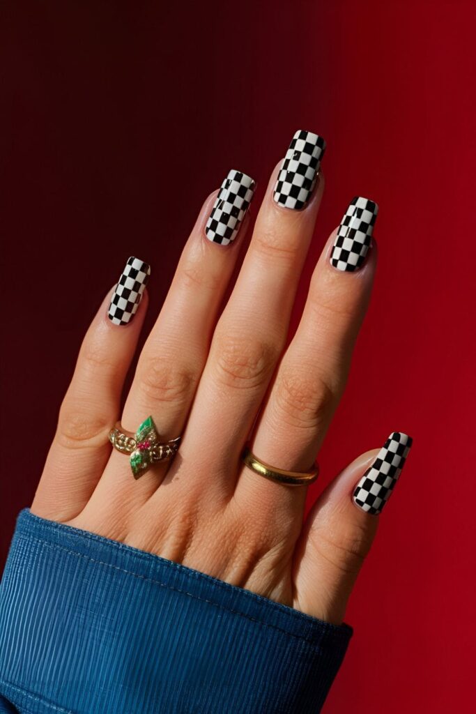 Nails designed with a black and white checkerboard pattern, or in bold, vibrant colors