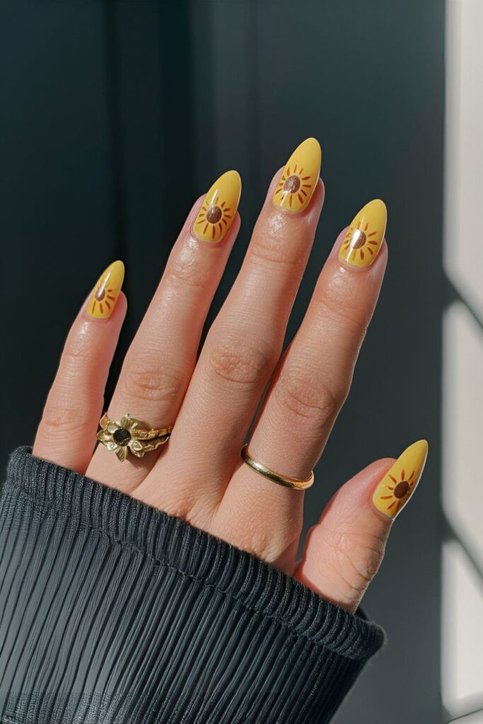 Nails featuring sunflower designs with yellow petals and brown centers, cheerful and nature-inspired nail art