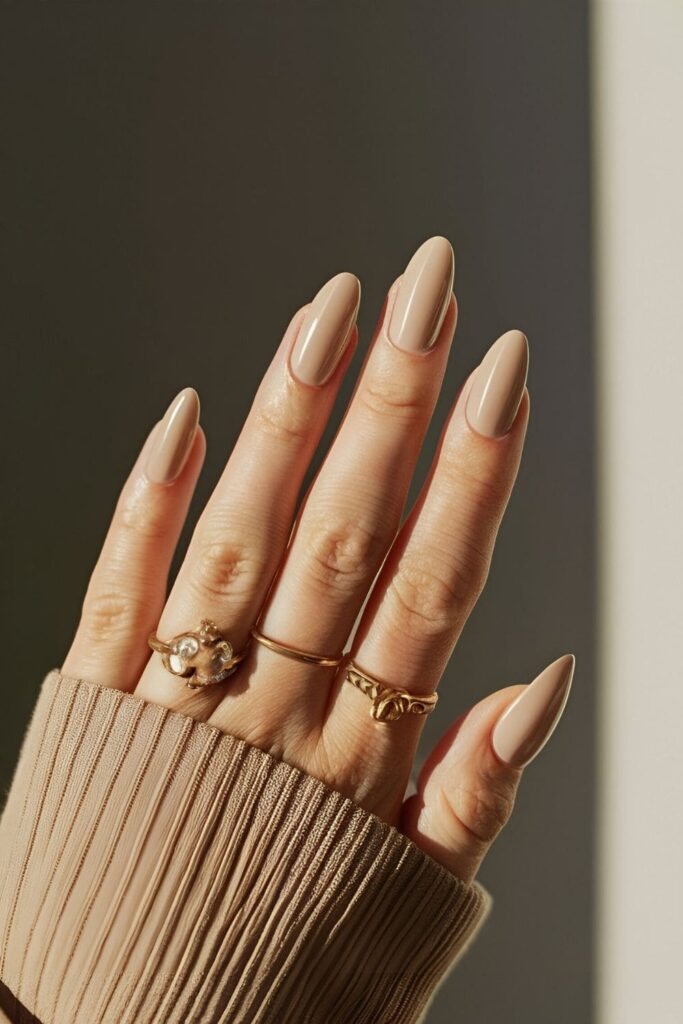 Nails in a creamy beige color, providing a neutral and elegant appearance with a soft and warm tone that complements any outfit